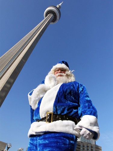 WestJet's Blue Santa made a whistle stop in Toronto, ON. where he made a trip up the CN Tower on Dec. 9, 2015 during the 12,000 Mini Miracle day.
