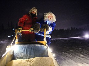 WestJet's Blue Santa took a side excursion to do a little dog sledding with Beck's Kennels employee Kaylee Youngdahl in Yellowknife, NT on Dec. 9, 2015 prior to making a special present drop off of new toys, food, treats and beds for the dogs at Beck's Sled Dog Kennels & Tours.