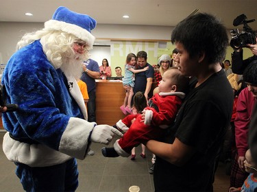 WestJet's Blue Santa said hello to dad Travis Turley and his five-month-old son Abel as he made his final mini miracle WestJet Christmas stop at the Ronald House British Columbia in Vancouver on Dec. 9, 2015.