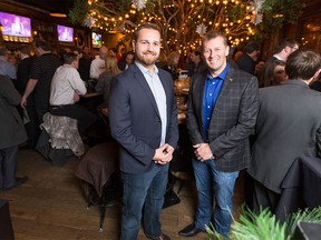 Wildrose MLA Derek Fildebrandt, left, and PCA MLA Mike Ellis stand together at a beer summit of small c conservatives at Wurst in Calgary on Monday, Dec. 14, 2015.