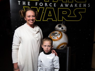 Shannon Wooward, left, stands with her son Loxley next to fan favourite droid BB-8 at the Star Wars opening weekend at Chinook Cineplex in Calgary on Thursday, Dec. 17, 2015.