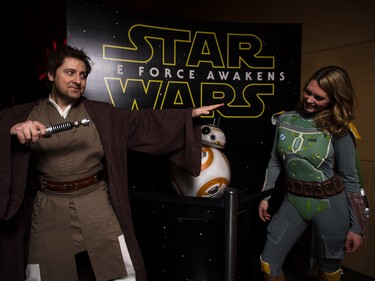 It's Jedi versus Mandalorian as Jedi Jay Donovan, left, strikes a pose with Boba Fett cosplayer Sharney Peters at the Star Wars opening weekend at Chinook Cineplex in Calgary on Thursday, Dec. 17, 2015.