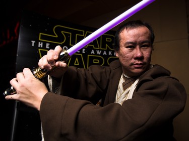 Jason Fong puts on his best Jedi stance at the Star Wars opening weekend at Chinook Cineplex in Calgary on Thursday, Dec. 17, 2015.