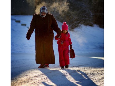 Maryam Farooq and her daughter Hafsa,4, arrive to help shovel sidewalks during the the Islamic Association of North West Calgary's shoveling around the residential neighbourhood along Ranchview Drive.