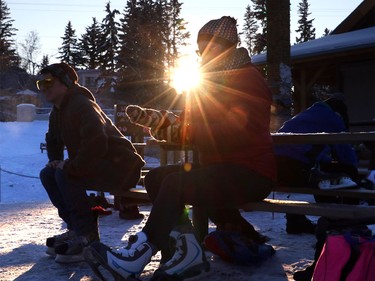 Calgarians like Maryjo Fairweather and her son Nathan enjoy a chilly white Christmas Day as they head to Bowness Park lagoon for skating, in Calgary on Dec. 25, 2015.