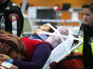 Patients are transported to hospital from the Calgary International Airport in Calgary on Wednesday, Dec. 30, 2015.