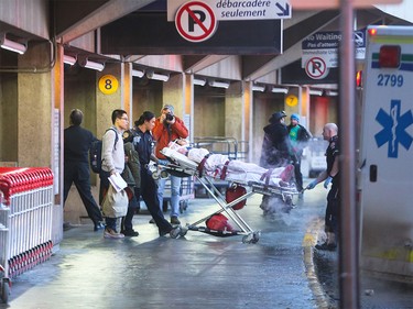 Patients are transported to hospital from the Calgary International Airport in Calgary on Wednesday, Dec. 30, 2015.