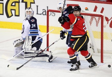 Calgary Flames Jiri Hudler, right, celebrates Johnny Gaudreau goal on Winnipeg Jets goalie Michael Hutchinson during their game at the Scotiabank Saddledome in Calgary on December 22, 2015.