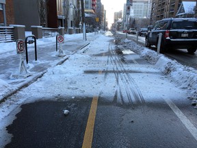 Snow pushed into the cycle track from a sidewalk in downtown Calgary.
