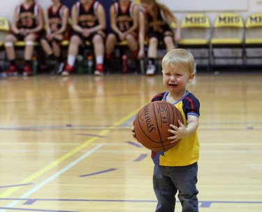 Sean Fyfe, 1, is upset he can't shoot hoops because halftime is over and he has to leave the court for the Junior Varsity Pandas to play the Junior Varsity Rebels in the Southern Alberta town of Magrath, on March 13, 2015. (Christina Ryan/Calgary Herald)