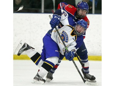 Regina Pats forward Randen Schmidt, right, battled against Calgary Royals forward Colton Young during game action at the Mac's AAA Midget Tournament at the Flames Community Arenas in Calgary on December 30, 2015.