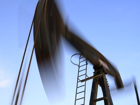 An oil pump works at sunset Monday, Dec.7, 2015, in the desert oil fields of Sakhir, Bahrain. U.S. stocks are dropping in early trading Monday as investors dump energy companies on lower oil prices. Benchmark U.S. crude is trading near its closing low for the year following a decision by OPEC last week not to cut production.