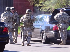 A swat team arrives at the scene of a shooting in San Bernardino, Calif. on Wednesday,  Dec. 2, 2015.  Police responded to reports of an active shooter at a social services facility.