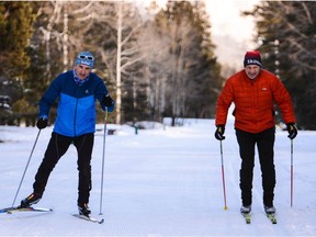 Two cross-country skiers at Tunnel Mountain in Banff National Park.