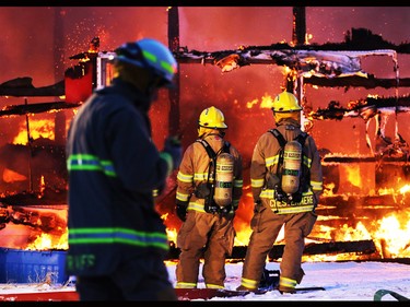 Firefighters deal with a large barn fire near Balzac northwest of Calgary on Friday evening.