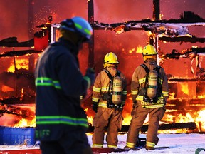 Firefighters deal with a large barn fire near Balzac northwest of Calgary on Friday evening.