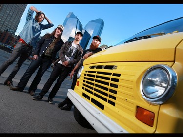 Calgary band Mancub from left, Sean Doherty, guitar, Kevin Ross, drums, Dan Kneeshaw, bass, and Trenton Bullard, vocals, stand next to their 1970 ford van in Calgary's beltline on Monday June 15, 2015.