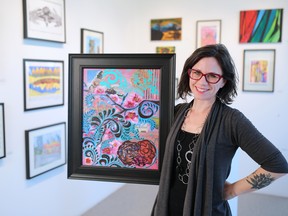 Artist Paula Timm holds her mixed media piece entitled "I wonder, Woman" in Studio C Gallery in the Burns Building downtown. Timm is one of the artists taking part in SPARK, a festival of artist with disabilities in galleries around Calgary.
(Gavin Young/Calgary Herald)
(For Entertainment section story by Stephen Hunt) Trax# 00070461A