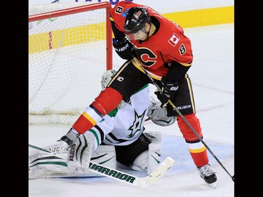 The Calgary Flames' Joe Colborne jumps as he looks for a loose puck stops this scoring chance in front of Dallas Stars goaltender Antti Niemi during second period NHL action on Tuesday December 1, 2015.