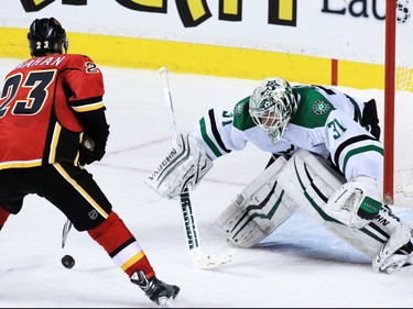 The Calgary Flames' Sean Monahan scores the winning shoot out goal on Antti Niemi to defeat the Dallas Stars 4-3 in NHL action on Tuesday December 1, 2015.