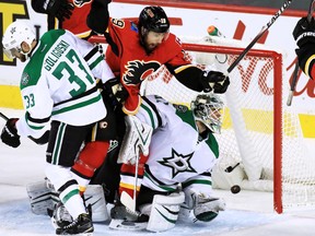 The Calgary Flames' David Jones celebrates as Johnny Gaudreau's shot goes past the Dallas Stars' Antti Niemi .