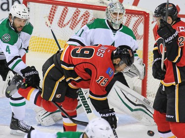 Calgary Flames winger David Jones gets tangled up in with the Dallas Stars' Jason Demers in front of goaltender Antti Niemi during NHL action in Calgary on Tuesday December 1, 2015.