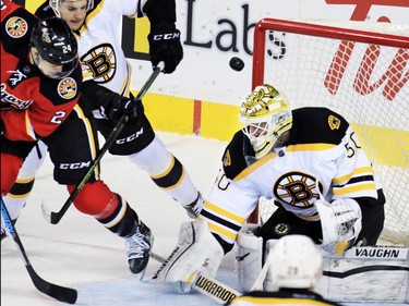 Centre Jiri Hudler fights for a rebound in front of Boston Bruins goaltender Jonas Gustavsson during the first period of NHL action at the Scotiabank Saddledome on Friday December 4, 2015.
