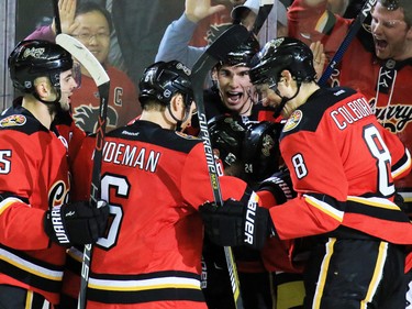 The Calgary Flames celebrate after Jiri Hudler scored in the final seconds to tie up the game against the Boston Bruins at the Scotiabank Saddledome on Friday December 4, 2015.