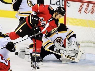 Calgary Flames Mikael Backlund looks for the puck in front of Boston Bruins goaltender Jonas Gustavsson during the first period of NHL action at the Scotiabank Saddledome on Friday December 4, 2015.