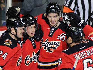 The Calgary Flames celebrate Johnny Gaudreau's second goal of the night against the Boston Bruins during the second period of NHL action at the Scotiabank Saddledome on Friday December 4, 2015.