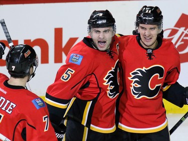 Calgary Flames from left, TY Brodie, Mark Giordano, and Mikael Backlund celebrate Backlund's goal during the second period of NHL action against the San Jose Sharks at the Scotiabank Saddledome on Tuesday December 8, 2015.