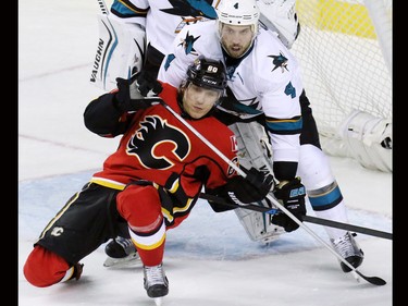 The  Calgary Flames' Markus Granlund and San Jose Sharks defender Brendan Dillon fight for position in front of the San Jose net during the second period of NHL action at the Scotiabank Saddledome on Tuesday December 8, 2015.