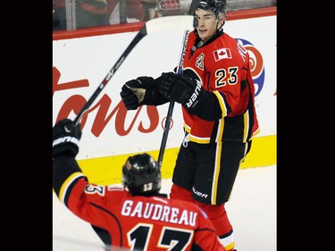 The Calgary Flames' Sean Monahan celebrates with Johnny Gaudreau after scoring on San Jose Sharks goaltender Martin Jones during the first period of NHL action at the Scotiabank Saddledome on Tuesday December 8, 2015.