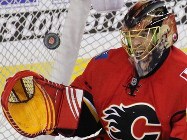 Calgary Flames goalie Jonas Hiller snatches the puck during a New York Ranger scoring chance in the the third period of NHL action in Calgary.