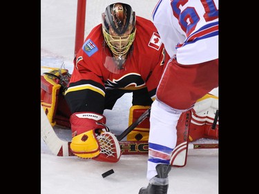 Calgary Flames goalie Jonas Hiller snatches the puck during a New York Ranger scoring chance in the the third period of NHL action in Calgary.