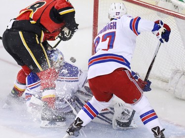 New York Rangers goaltender Antti Raanta has a close call during this Calgary Flames scoring chance during the first period of NHL action in Calgary on Saturday December 12, 2015.