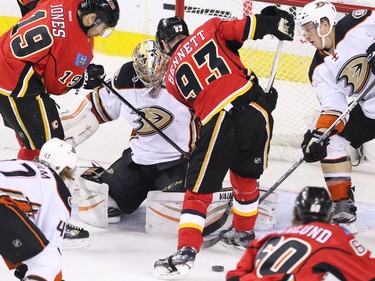 Calgary Flames David Jones and Sam Bennett fight to get a loose puck past Anaheim Ducks goaltender John Gibson during NHL action at the Scotiabank Saddledome on Tuesday November 29, 2015.