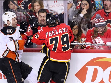 Fans react as the Calgary Flames' Micheal Ferland lands a hit on the Anaheim Ducks' Clayton Stoner during NHL action at the Scotiabank Saddledome on Tuesday November 29, 2015.