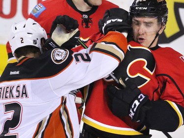 The Anaheim Ducks' Kevin Bieksa and the Flames Mikael Backlund vent their frustrations in the closing minutes of the third period at the Scotiabank Saddledome on Tuesday November 29, 2015. The Ducks won the game 1-0.