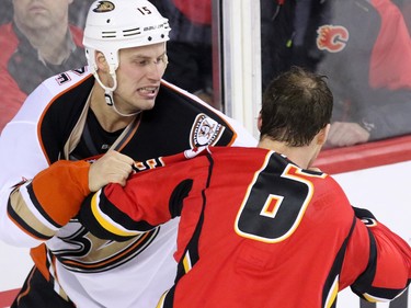 The Anaheim Ducks' Ryan Getzlaf and the Flames Dennis Wideman tangle after the end of the third period at the Scotiabank Saddledome on Tuesday November 29, 2015. The Ducks won the game 1-0.