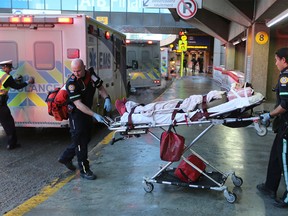 Injured passengers from an Air Canada Boeing 777 are transported by Calgary EMS crews after the Shanghai to Toronto flight experienced severe turbulence.