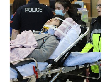 Injured passengers from an Air Canada Boeing 777 are transported by Calgary EMS crews after the Shanghai to Toronto flight experienced severe turbulence.