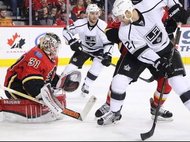 The Los Angeles Kings Nick Shore looks for the loose puck in front of Calgary Flames goaltender Karri Ramo during NHL action at the Scotiabank Saddledome on New Year's Eve December 31, 2015.