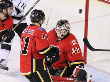 The puck flies over Calgary Flames goaltender Karri Ramo during NHL action against the Los Angeles Kings at the Scotiabank Saddledome on New Year's Eve December 31, 2015.