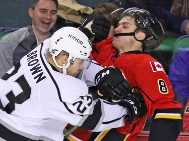 The Los Angeles Kings Dustin Brown and the Flames' Joe Colborne collide during NHL action at the Scotiabank Saddledome on New Year's Eve December 31, 2015.