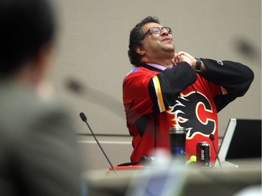 CALGARY, AB.; APRIL 13, 2015   --  Wearing his Calgary Flames playoff jersey Mayor Naheed Nenshi enjoys a lighter moment during the city council debate on council seating arrangements Monday April 13, 2015. (Ted Rhodes/Calgary Herald) For City  story by Jason Markusoff. Trax # 00064193A