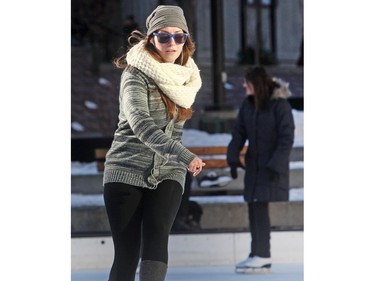 Justine Dunn, calling herself a hockey player by nature, enjoys a relaxing noon hour skate in the sunshine after classes on the Olympic Plaza rink Tuesday December 1, 2015. Predictions are for a sunny and warmer than usual winter this year.