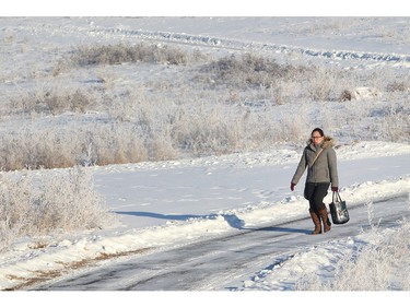 Florence Evangelista walks on the pathway down the frost covered slopes above Max Bell Arena on Boxing Day morning December 26, 2015. She was headed to opening day of the annual Macs Midget Tournament at the arena.