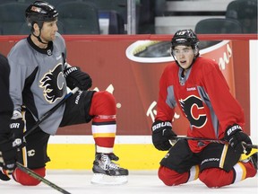 Johnny Gaudreau of the Calgary Flames chats with defenceman Dennis Wideman during practice Monday December 28, 2015.