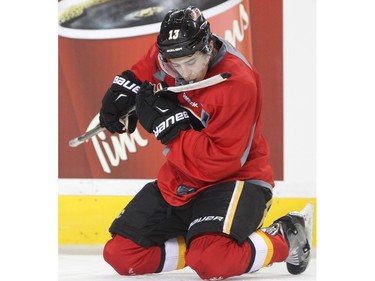 Johnny Gaudreau of the Calgary Flames does an up-lose inspection of his stick during practice Monday December 28, 2015. He has been named the NHL's First Star for the week ending December 27.